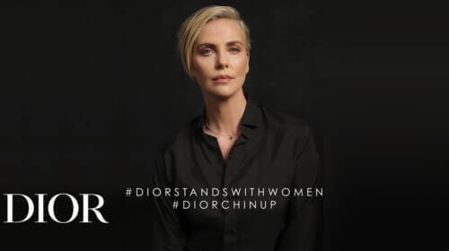Photo of Charlize Theron with text that reads #DIORSTANDSWITHWOMEN #DIORCHINUP